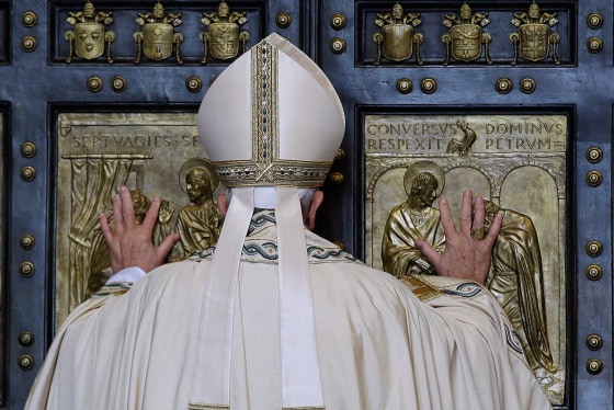 Pope Francis pushes open the Holy Door of St. Peter's Basilica, formally launching the Holy Year of Mercy, at the Vatican on Tuesday, Dec. 8, 2015. 