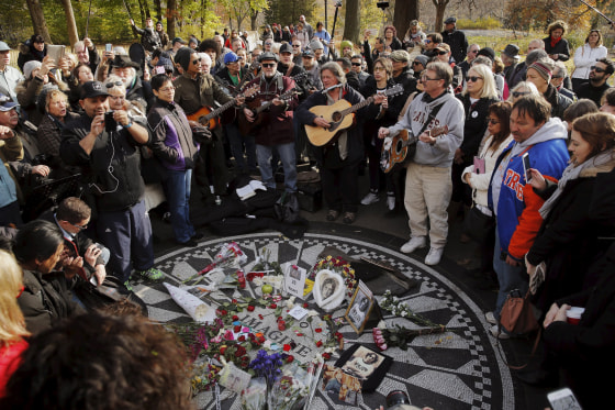 Image: Fans of former Beatle Lennon gather at the Imagine mosaic in the Strawberry Fields section of New York's Central Park to mark the 35th anniversary of his death, in New York