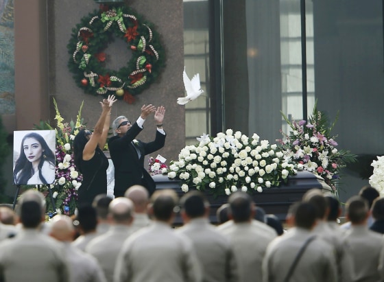 Image: Parents of San Bernardino shooting victim Velasco release a white dove over her casket during memorial service in Covina