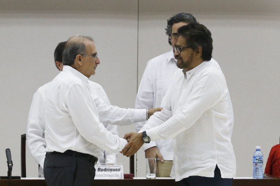 Image: Colombia's lead government negotiator Humberto de la Calle and Colombia's FARC lead negotiator Ivan Marquez (R) shake hands in Havana