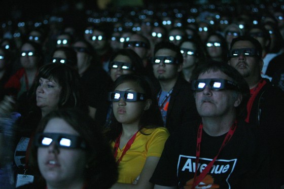 Image: Visitors wear 3D glasses as they watch a movie