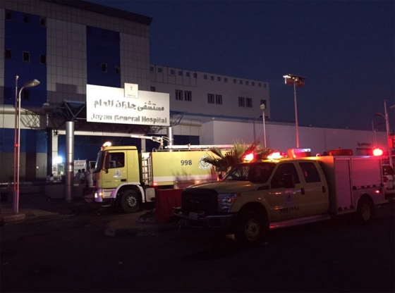 Officials at the scene of a hospital fire Thursday, Dec. 24, in Jazan, Saudi Arabia. At least 25 people were reportedly killed and over 100 others were injured.