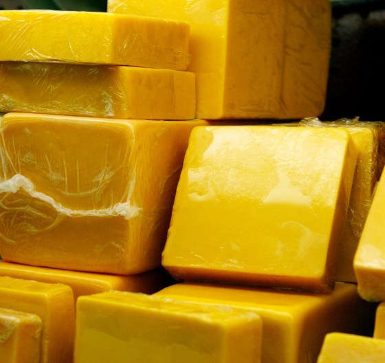 Image: Blocks of two-year cheddar cheese are displayed