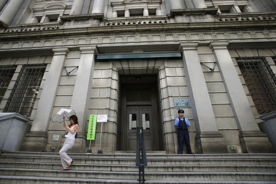 A woman leaves the Bank of Japan's headquarters in Tokyo in 2013.