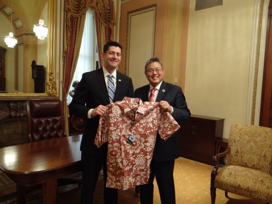 Rep Mark Takai (D-HI) giving House Speaker Paul Ryan an aloha shirt to encourage Ryan to allow aloha wear to be worn on the House floor on Fridays.
