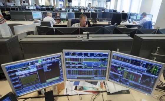 Traders look at screens on the KBC bank trading floor in Brussels