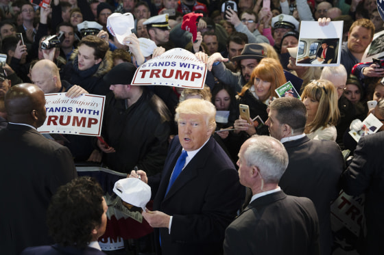 Image: Donald Trump signs autographs during a campaign stop