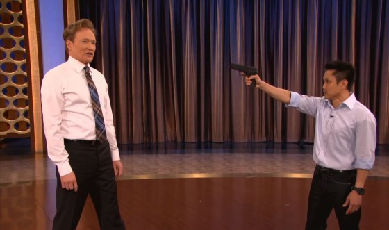Steven Ho teaching Conan O'Brien gun defense techniques on \"Conan.\"