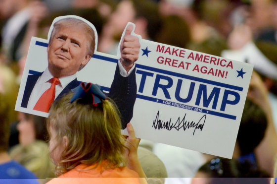 Image: A young supporter holds up a campaign sign for U.S. Republican Presidential candidate Donald Trump at a campaign rally in Madison Mississippi