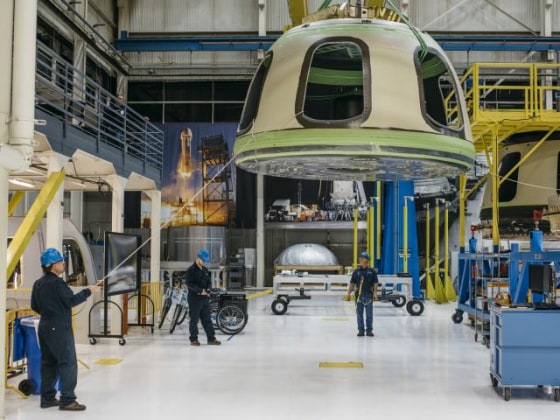 Handout Blue Origin photo shows Blue Origin team members ready the New Shepard Crew Capsule during assembly in Kent, Washington