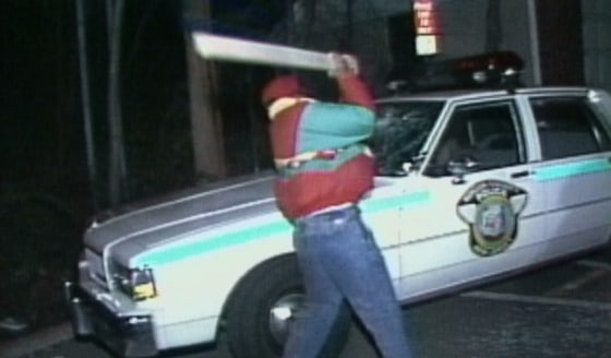 Image: A protester smashes a Teaneck Police car during protests in 1990