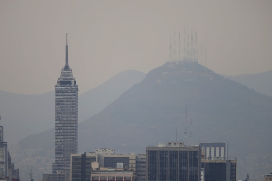 Image: Buildings stand shrouded in smog in Mexico City