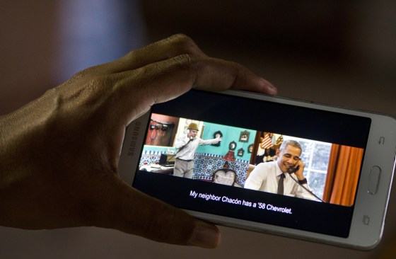 A cell phone shows a frame from the video released by the White House of President Barack Obama joking with Cuban comedian Pánfilo.