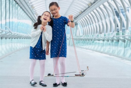 9-year-old Kimberly Yeung (left) and 11-year-old Rebecca Yeung holding the Loki Lego Launcher at the Museum of Flight in Seattle.