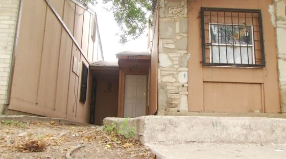 Image: woman arrested after toddlers found chained outside home