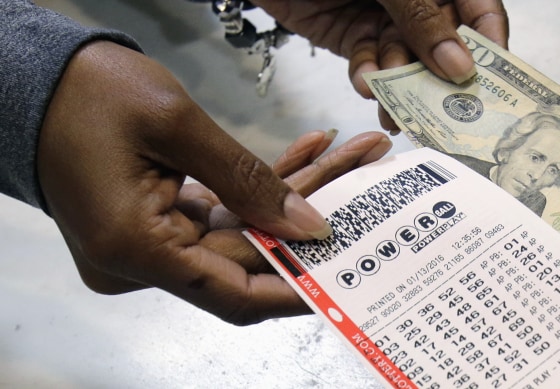 In this Jan. 13, 2016 file photo, a clerk hands over a Powerball ticket for cash at Tower City Lottery Stop in Cleveland. Powerball estimates that its jackpot for the May 4, 2016, drawing is $348 million.