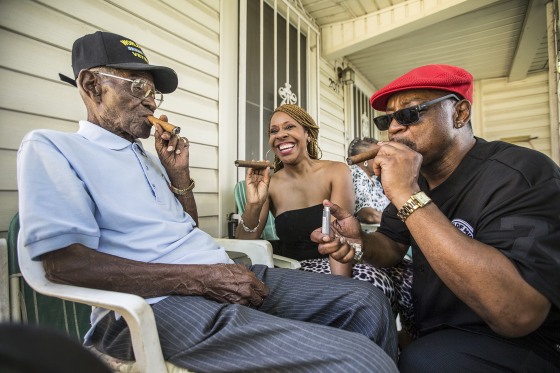 Richard Overton, left, smokes a cigar with a few neighborhood friends Donna Shorts, center and Martin Wilford Sunday, May 3, 2015, in Austin, Texas.