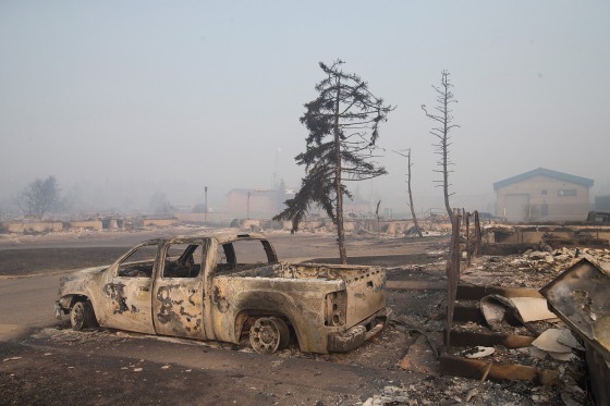 Image: Home foundations and shells of vehicles are nearly all that remain in a residential neighborhood destroyed by a wildfire