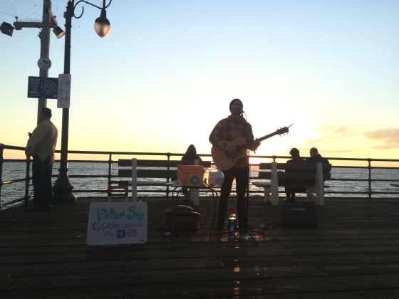 Peter Su, a former investment banker and venture capitalist, busking at the Venice Beach pier in Los Angeles.