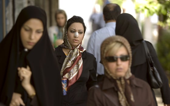 Arezoo Abassi walks along a street in Tehran