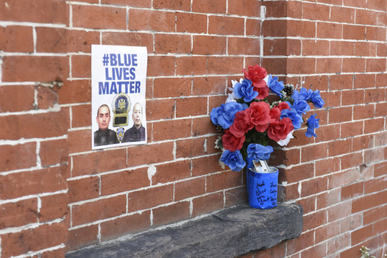 This 'Blue Lives Matter' poster was placed on a brick wall near the site where New York City police officers Wejian Liu and Rafael Ramos were shot and killed at point-blank range in their patrol car in December 2010.