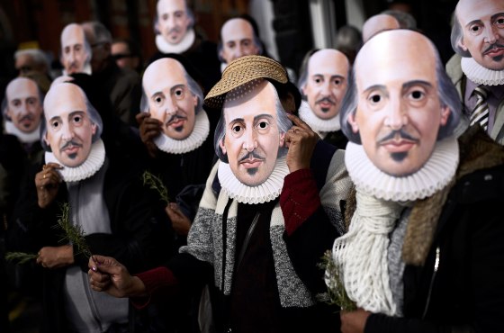 Image: People hold up face masks with William Shakespeare's portrait during celebrations to mark the 400th anniversary of the playwright's death in the city of his birth, Stratford-Upon-Avon
