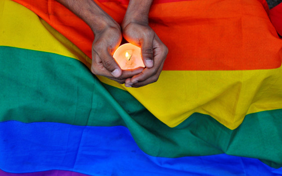 Image: A member of the LGBT community in Bengalaru holds a candle during a memorial service following a mass shooting at the Pulse gay nightclub in Orlando