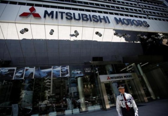 A security personnel walks in front of Mitsubishi Motors Corp's headquarters in Tokyo, Japan