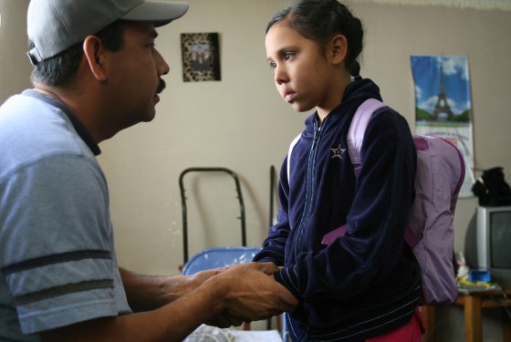Abel Munoz offers his daughter Adilene, 8, some words of encouragement as she readies to head back