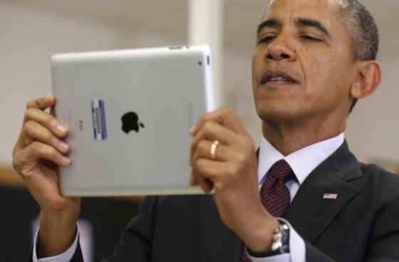 U.S. President Barack Obama holds up an iPad during a visit to Buck Lodge Middle School in Adelphi