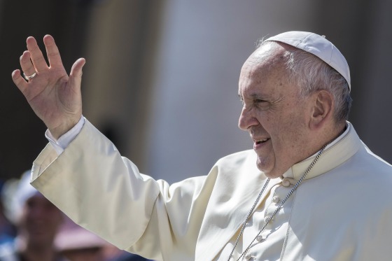Pope Francis greets the faithful as he arrives to celebrate