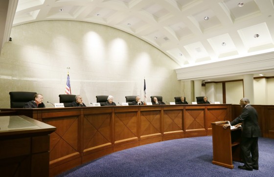 Des Moines attorney Alfredo Parrish, right, speaks during a hearing in the Iowa Supreme Court chambers, on Aug. 27, 2014, in Des Moines, Iowa. The Iowa Supreme Court held the hearing to get input into a proposal by the Iowa State Bar Association.