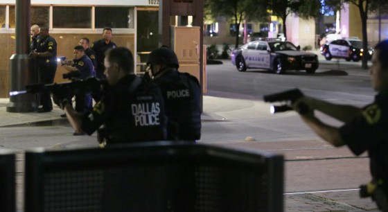 Image: Dallas police move to detain a driver after several police officers were shot in downtown Dallas