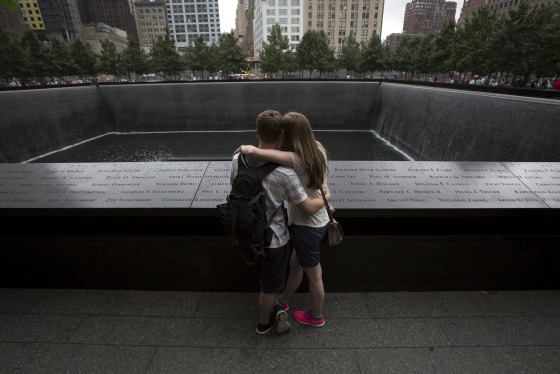 Image: People embrace at the National September 11 Memorial and Museum in Lower Manhattan in New York
