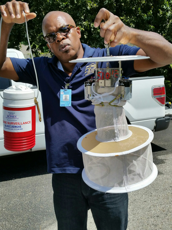Maximea Vigilant, a surveillance entomologist for Harris County, Texas, checks a mosquito trap in Houston.