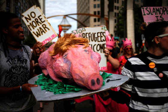 Image: Activists carry a prop during protest march by various groups ahead of Republican National Convention in Cleveland, Ohio