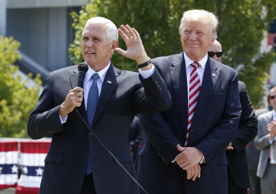 Image: Republican U.S. presidential candidate Trump listens to Pence after arriving in Cleveland, Ohio