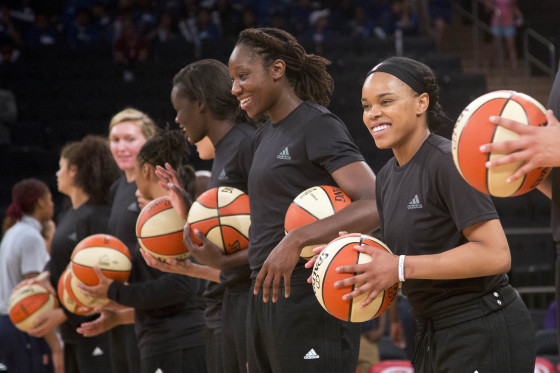Members of the New York Liberty basketball team await the start of a game against the Atlanta Dream, Wednesday, July 13, 2016 in New York. Between the Black Lives Matter movement, the Orlando shooting and the LGBT community, more WNBA players have been taking active roles in expressing their views on social issues. In the midst of Camp Day? at the New York Liberty's mid-morning game Wednesday, Liberty players stood in solidarity as they donned all-black warmups in support of the Black Lives Matter movement.