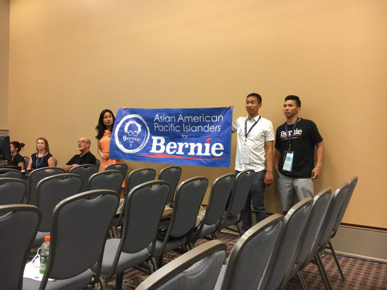 Supporters of Sen. Bernie Sanders arrive at the AAPI Caucus meeting, at the Pennsylvania Convention Center, with a banner, July 25, 2016.