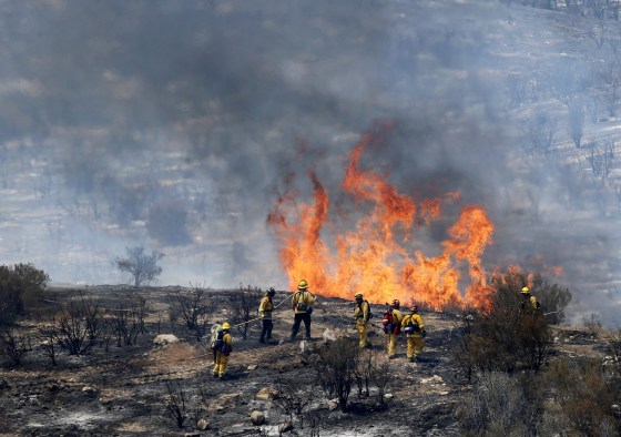 Image: Firefighters let a small area of the Sand Fire burn out near Acton