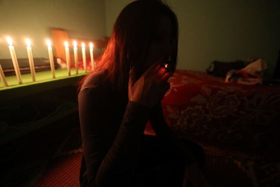 FILE PHOTO: A Syrian sex trafficking victim smokes a cigarette at her safe house