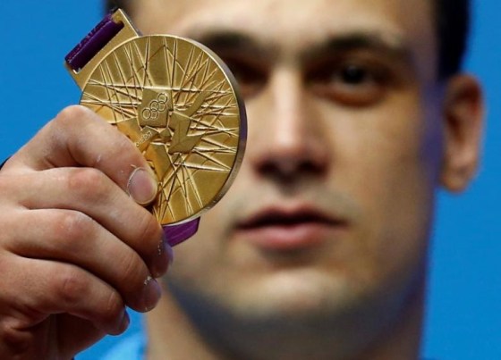 Kazakhstan's Ilya Ilyin poses with his gold medal of the men's 94Kg weightlifting competition at the ExCel venue at the London 2012 Olympic Games