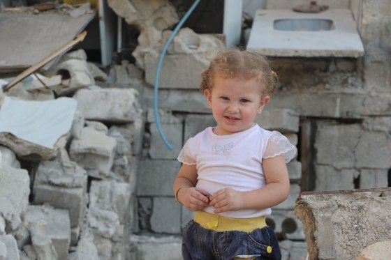 Image: Elaph Bijo, 2, likes to play with the family chickens but it's too dangerous for her to go outside.