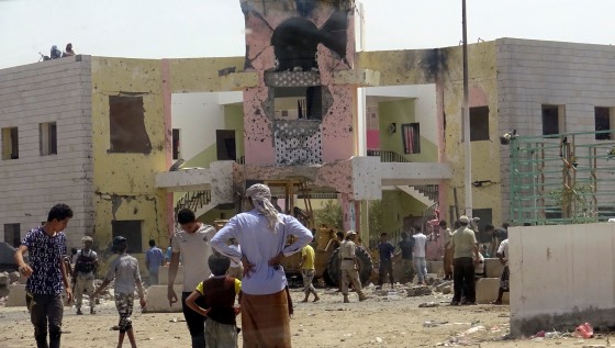 People gather at the scene of the Aden attack