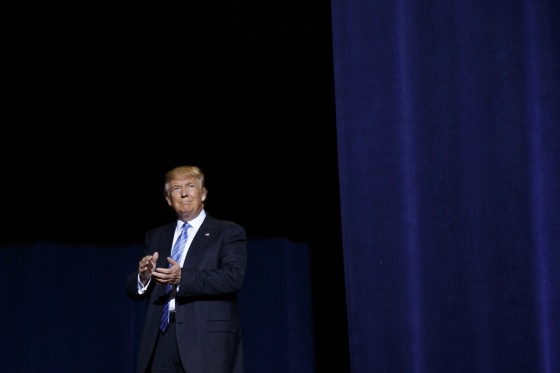 Image: Donald Trump arrives to deliver an immigration policy speech