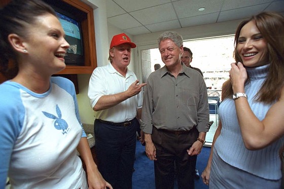 President Bill Clinton talks with Donald Trump, as Melania Knauss, right, Trump's future wife, and an unidentified woman look on at the U.S. Open Tennis Championship match in New York on on Sept. 8, 2000.
