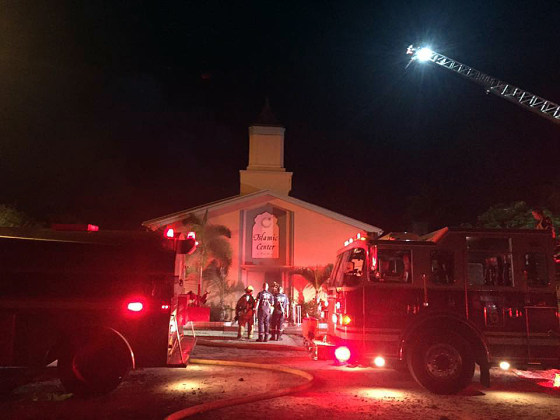 Firefighters work at the scene of a fire at the Islamic Center of Fort Pierce, Florida, early on Sept. 12.
