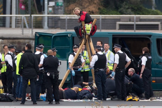 Image: Emergency services surround protesters at London City Airport