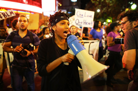 Image: A protester speaks through a megaphone during another night of protests over the police shooting of Keith Scott in Charlotte