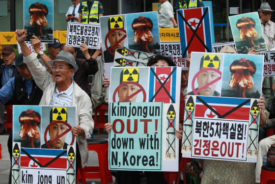 Image: South Korean protesters with defaced pictures of North Korean leader Kim Jong Un during a rally